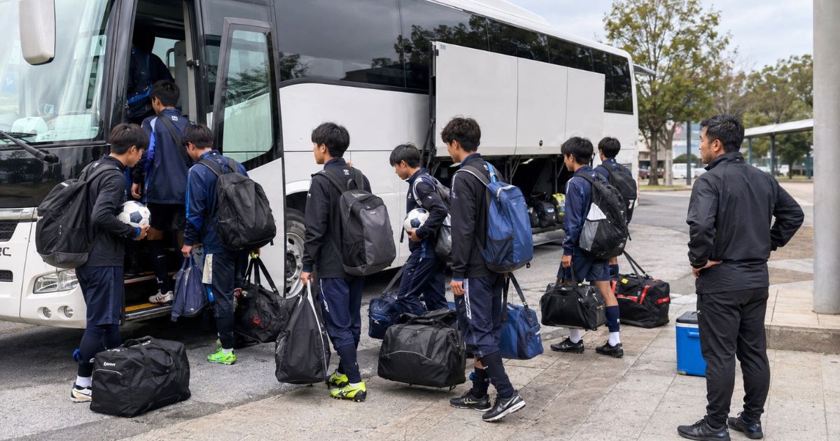 遠征へ出発するため、サッカー用具やバッグを持ってチームバスに乗り込む高校生年代の選手たち